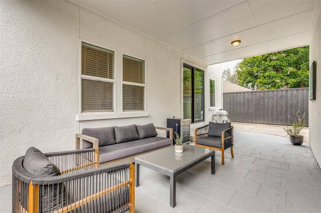 Covered patio featuring concrete tile flooring, stucco exterior walls, and recessed lighting