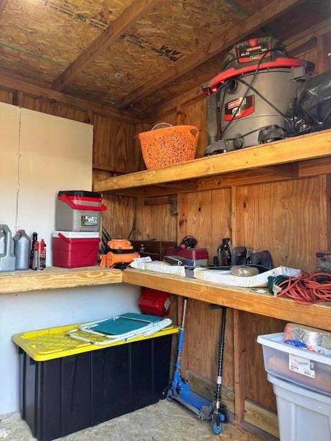 Enclosed storage area featuring tiered fixed shelving