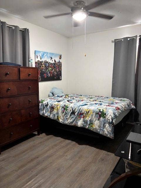 Wood-finish flooring, and a ceiling-mounted light fixture with an integrated fan
