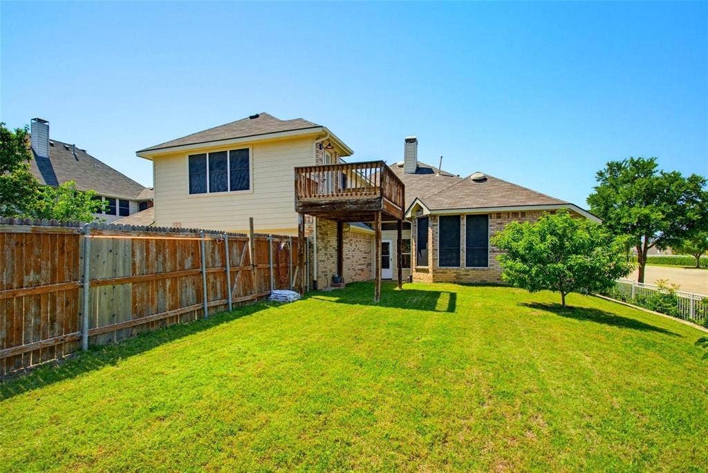 4402 Horizon Drive, Garland, TX 75043 Backyard featuring a grass lawn, wood privacy fencing, and an elevated wooden deck
