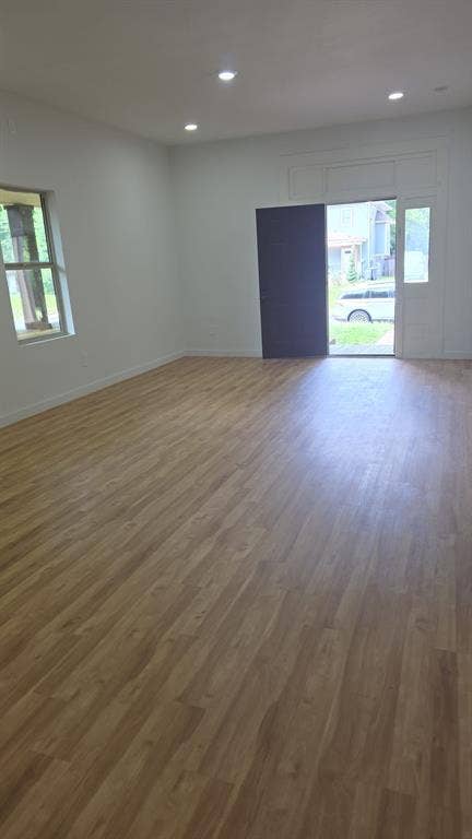 4643 Luzon Street, Dallas, TX 75216 Open-concept interior featuring light wood-finish flooring, recessed lighting, white walls, and an exterior door with a sidelight window