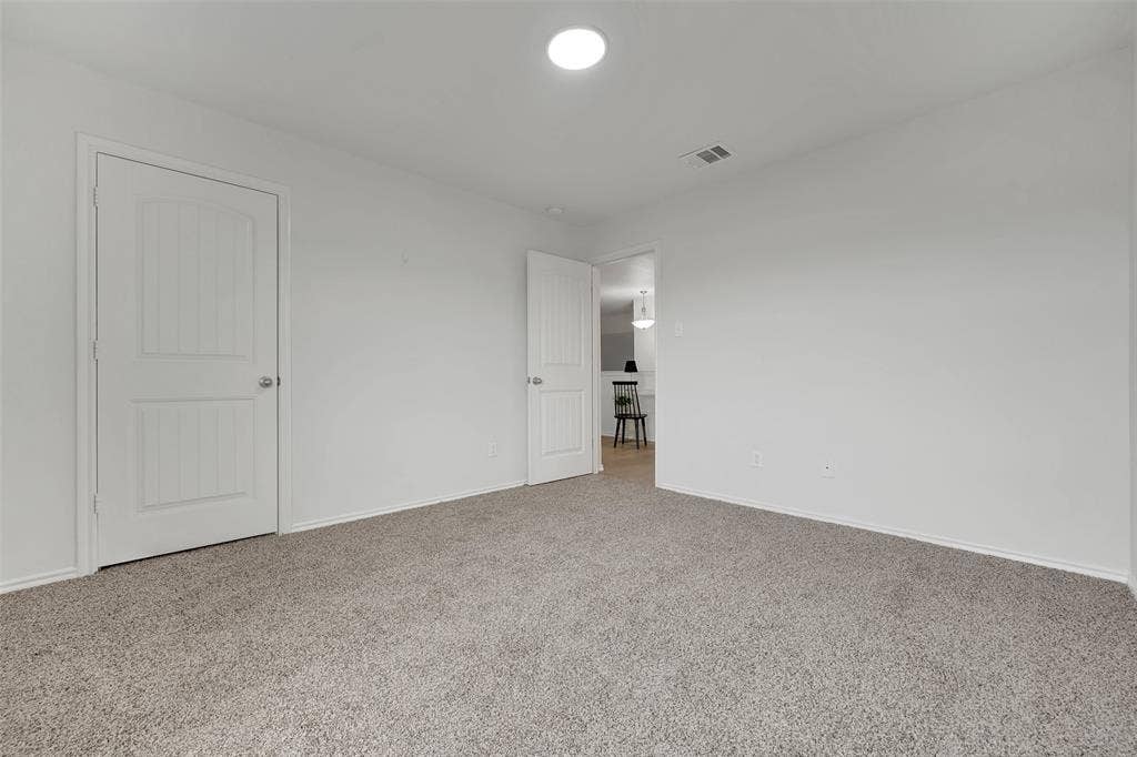1121 Basswood Lane, Royse City, TX 75189 Unfurnished bedroom featuring visible vents, baseboards, and carpet