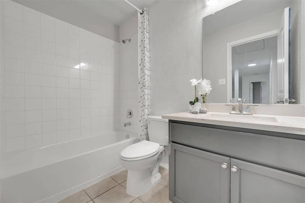 1121 Basswood Lane, Royse City, TX 75189 Full bathroom with vanity, tile patterned floors, toilet, and shower / tub combo with curtain