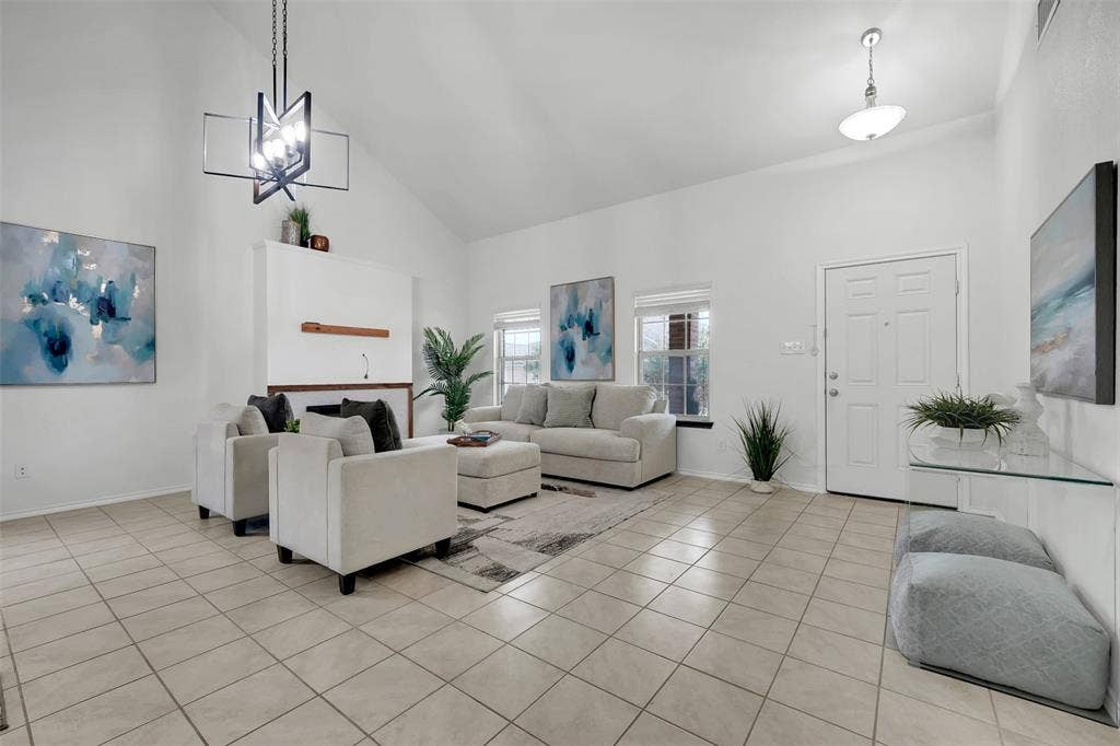 1121 Basswood Lane, Royse City, TX 75189 Living area featuring light tile patterned floors, baseboards, high vaulted ceiling, and an inviting chandelier