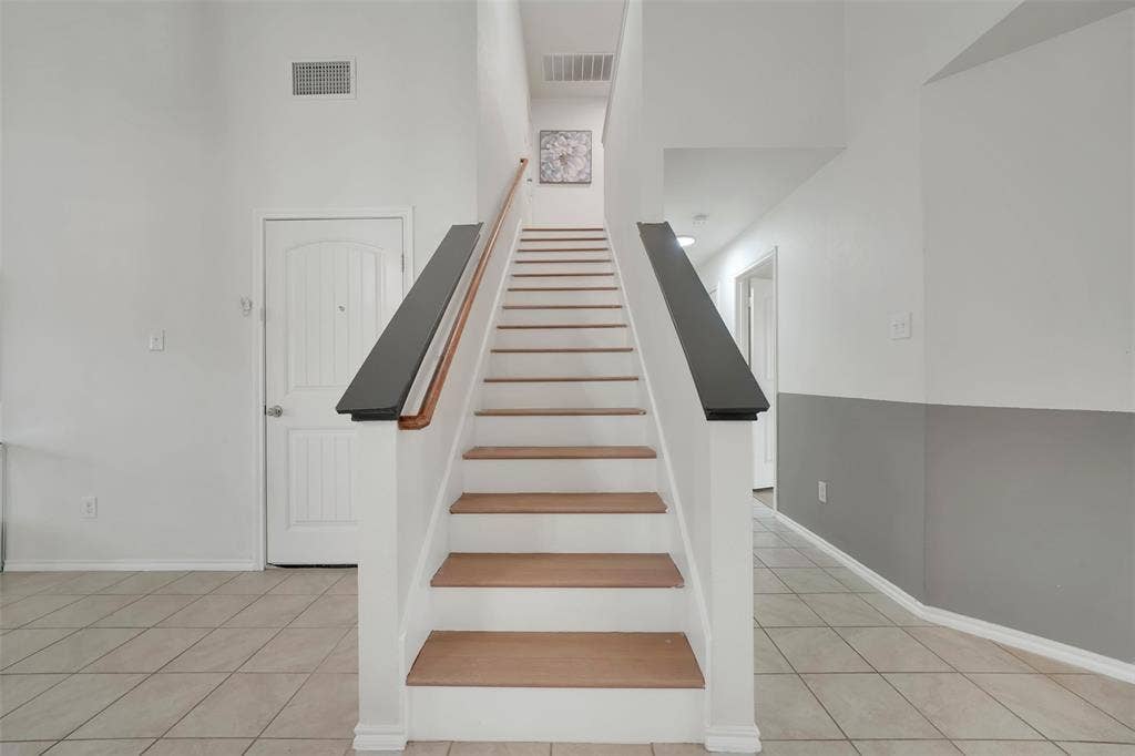 1121 Basswood Lane, Royse City, TX 75189 Stairway with tile patterned floors, visible vents, and baseboards