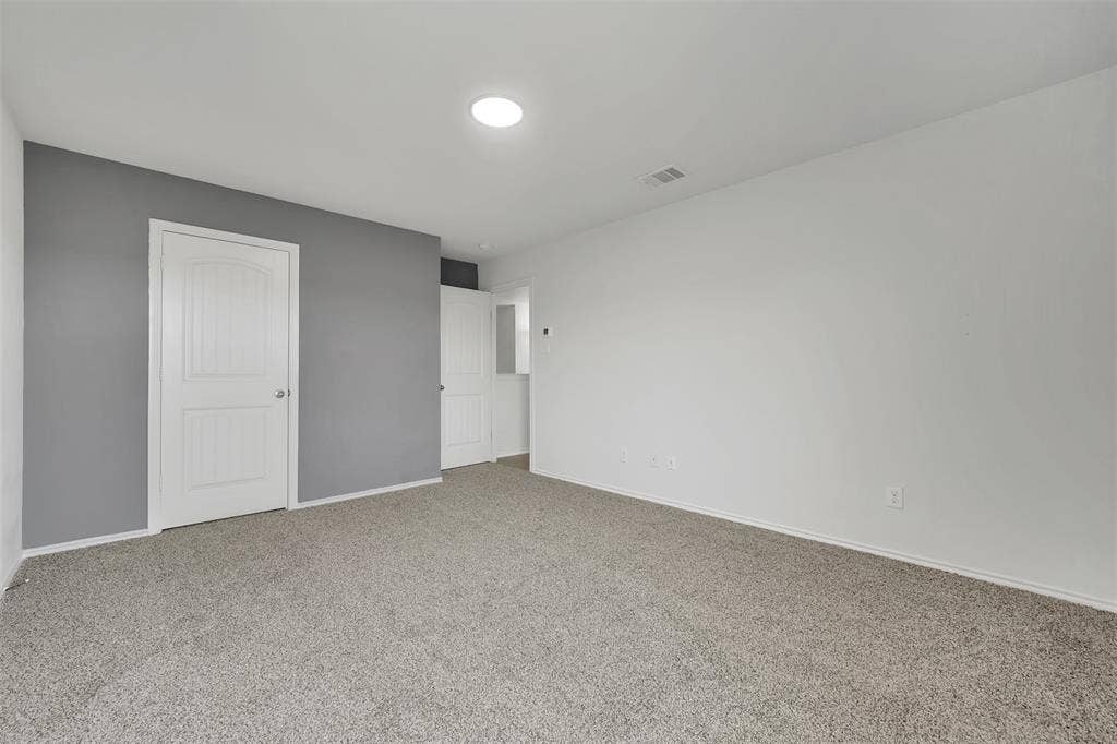 1121 Basswood Lane, Royse City, TX 75189 Unfurnished bedroom with visible vents, baseboards, and carpet