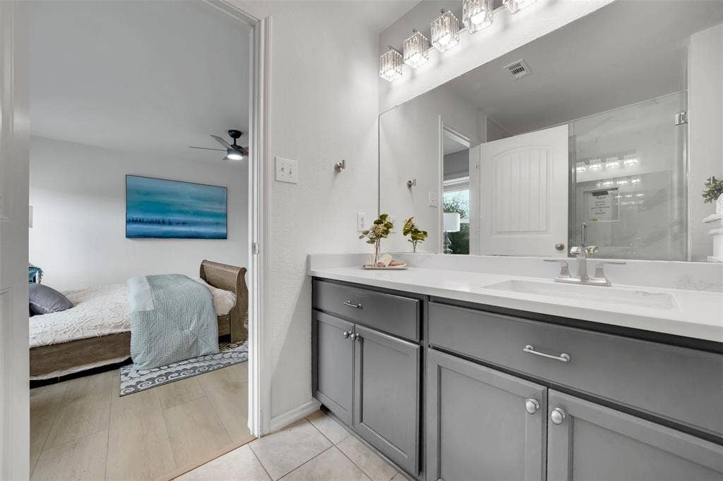 1121 Basswood Lane, Royse City, TX 75189 Ensuite bathroom featuring visible vents, connected bathroom, ceiling fan, tile patterned floors, and vanity