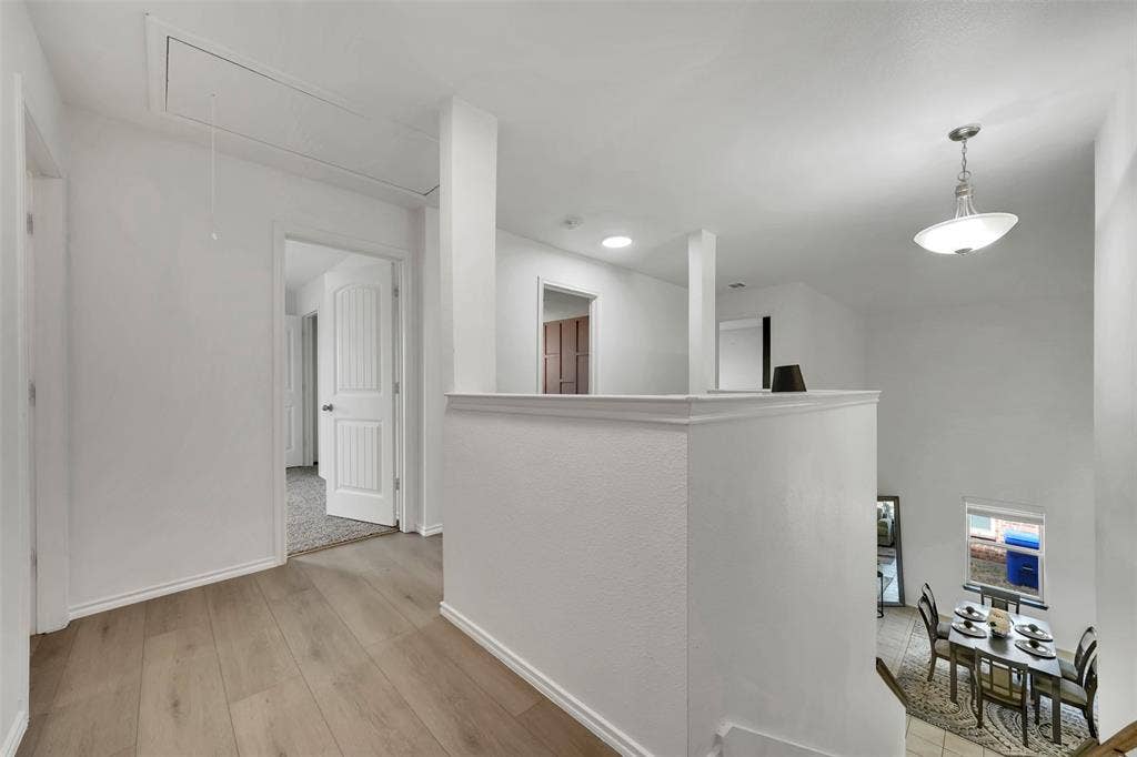 1121 Basswood Lane, Royse City, TX 75189 Hall with light wood-style flooring, attic access, and baseboards