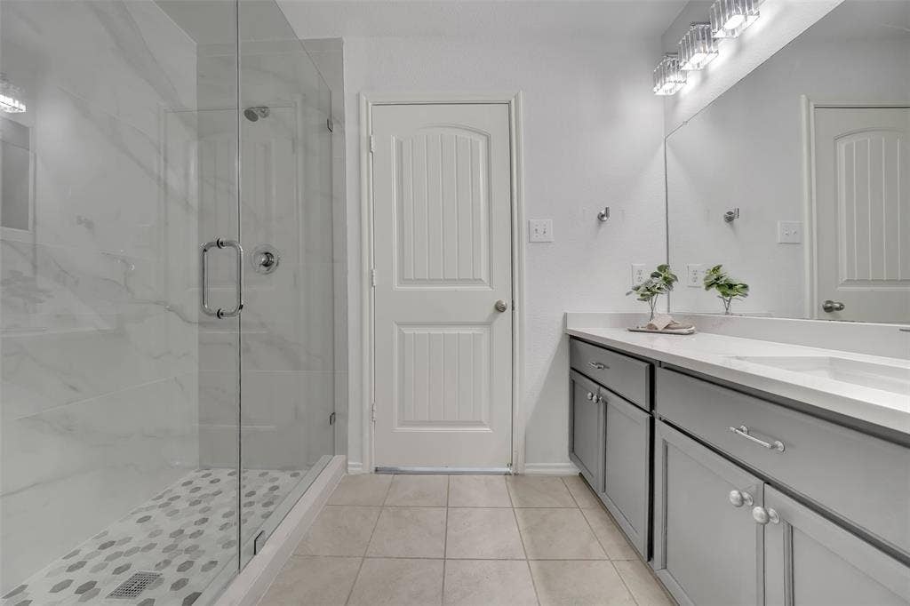 1121 Basswood Lane, Royse City, TX 75189 Full bathroom featuring vanity, baseboards, a stall shower, and tile patterned flooring