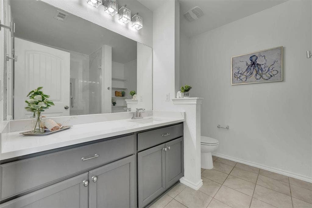 1121 Basswood Lane, Royse City, TX 75189 Bathroom with tile patterned floors, visible vents, toilet, baseboards, and vanity