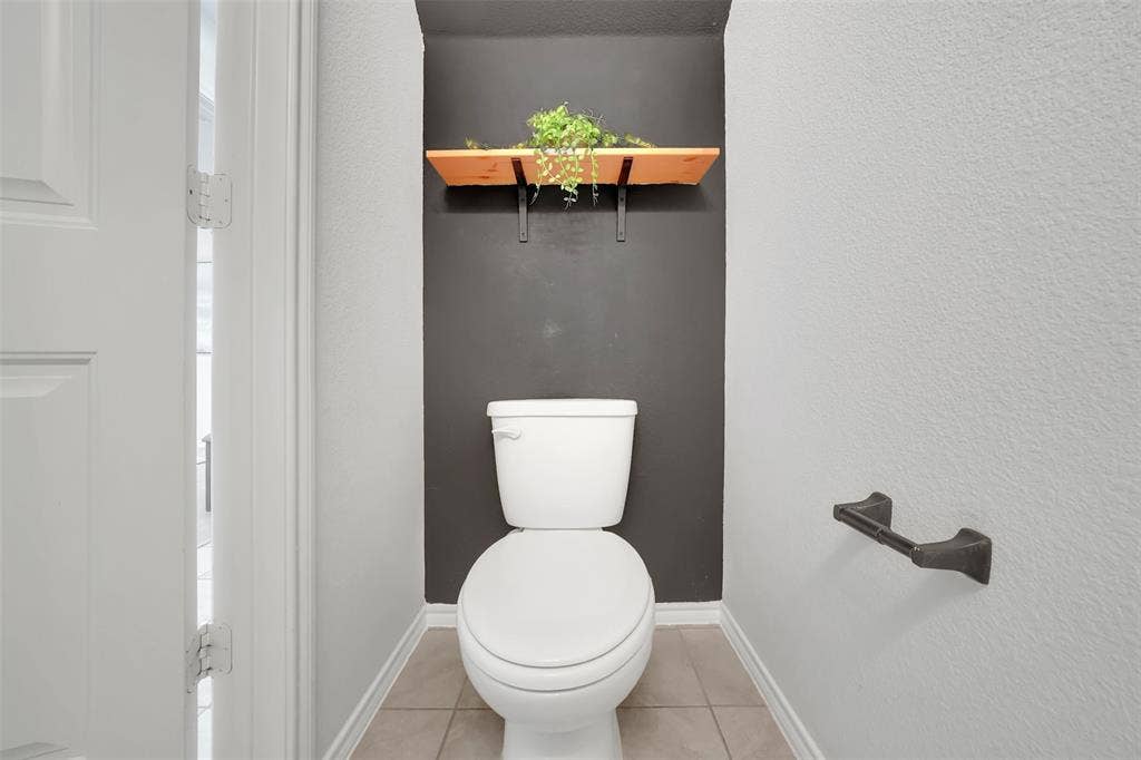 1121 Basswood Lane, Royse City, TX 75189 Bathroom with tile patterned floors, baseboards, and toilet