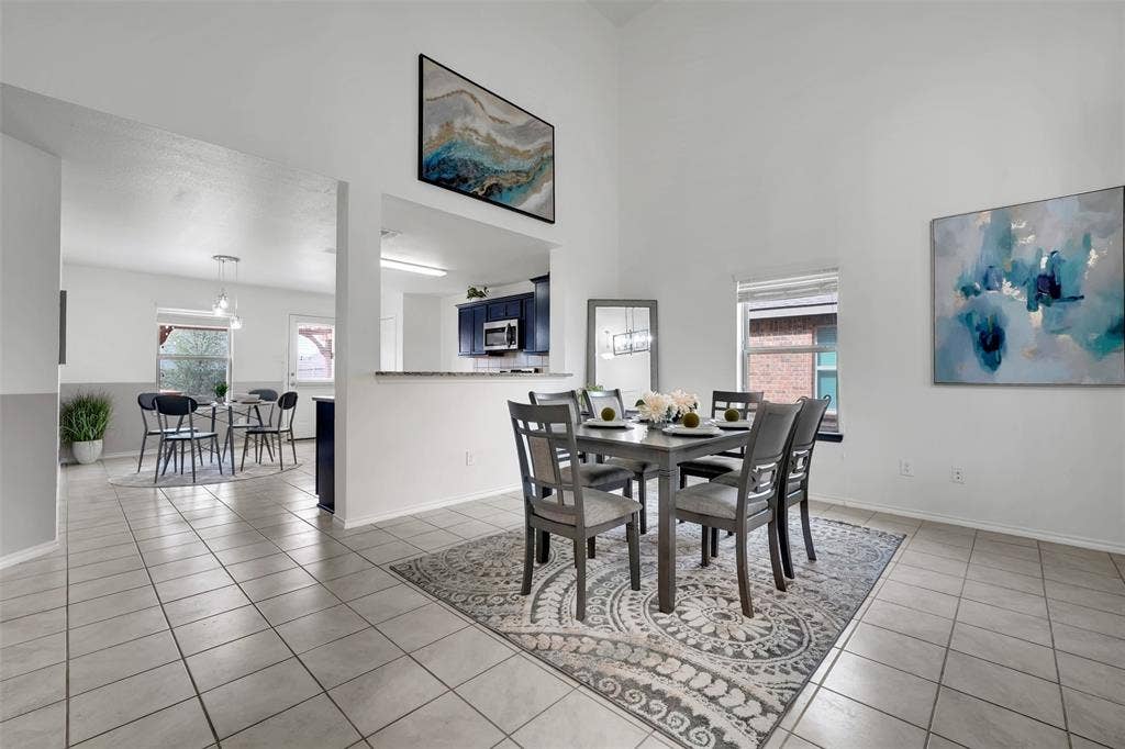 1121 Basswood Lane, Royse City, TX 75189 Dining space with light tile patterned floors, baseboards, and a towering ceiling