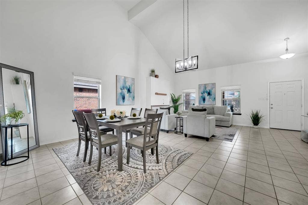 1121 Basswood Lane, Royse City, TX 75189 Dining space featuring light tile patterned floors, baseboards, high vaulted ceiling, and a wealth of natural light
