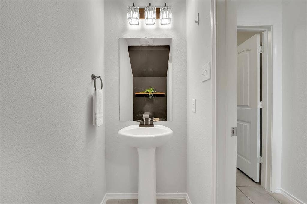 1121 Basswood Lane, Royse City, TX 75189 Bathroom featuring tile patterned flooring and a textured wall