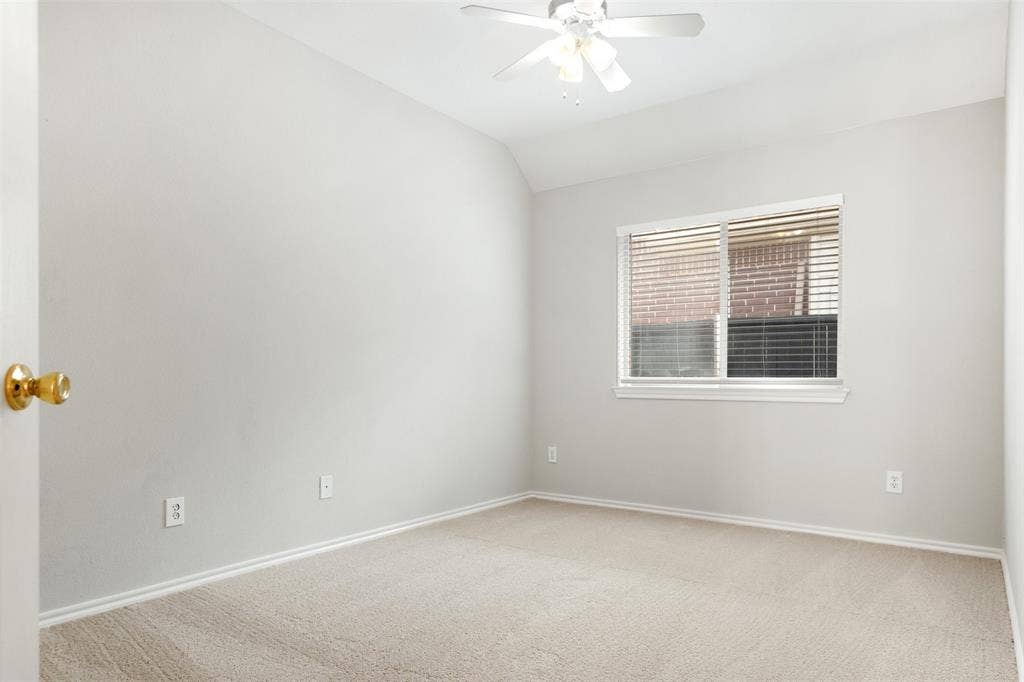 2803 Pheasant Run Drive, McKinney, TX 75072 Neutral-toned room featuring high vaulted ceilings, wall-to-wall carpeting, and a central ceiling fan with an integrated light fixture