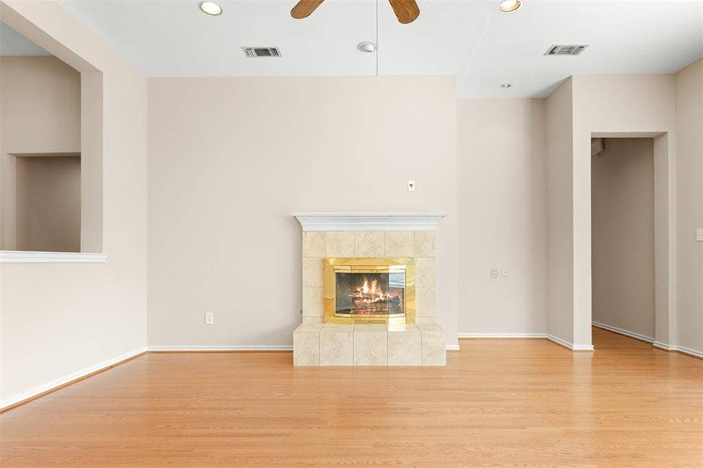 2803 Pheasant Run Drive, McKinney, TX 75072 Fireplace with tile surround, wood-finish flooring, ceiling fan, and recessed lighting