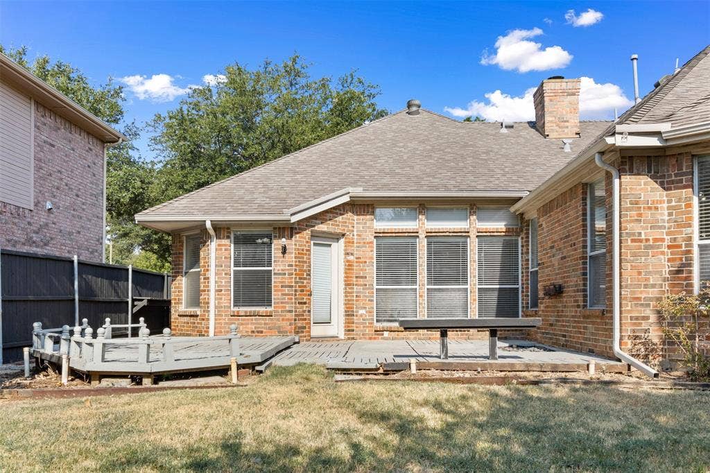 2803 Pheasant Run Drive, McKinney, TX 75072 Brick exterior featuring a multi-level raised deck, integrated patio space, and masonry chimney
