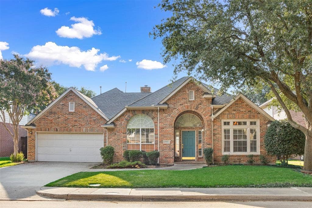 2803 Pheasant Run Drive, McKinney, TX 75072 Brick exterior featuring an arched entryway, gabled rooflines, multi-pane windows, and a two-car garage