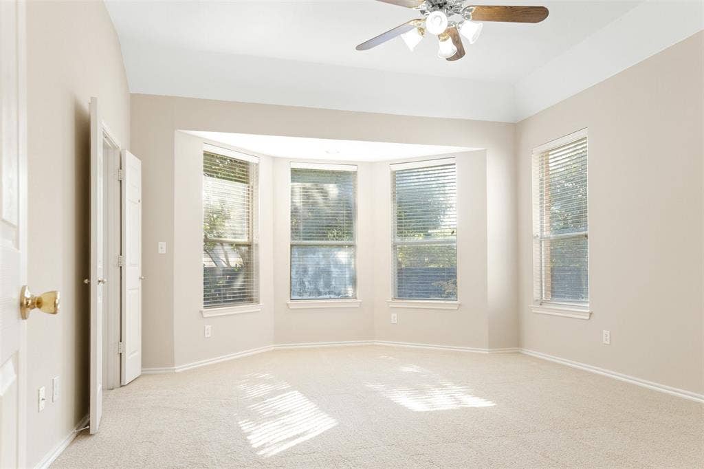 2803 Pheasant Run Drive, McKinney, TX 75072 Room featuring neutral wall-to-wall carpeting, vaulted ceiling with a central multi-light ceiling fan, and a three-paneled bay window