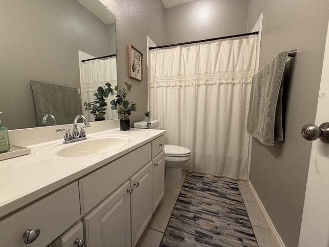 11159 Covey Lane, Frisco, TX 75035 Vanity featuring a white countertop with an integrated oval sink, dual-handle chrome faucet, wall-mounted mirror, and white shaker-style cabinetry