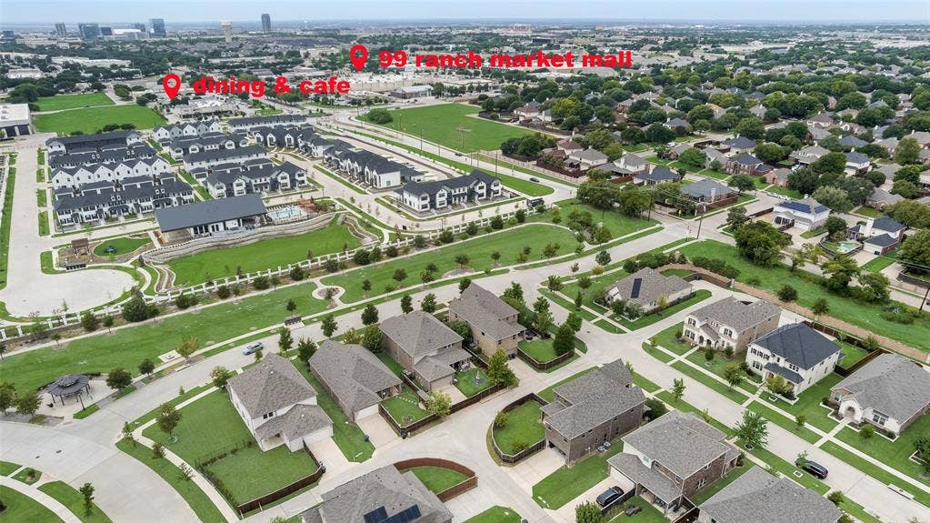 9829 Sharps Drive, Frisco, TX 75035 Aerial perspective of a master-planned community featuring greenbelts, landscaped common areas, a central swimming pool, and proximity to retail and dining centers
