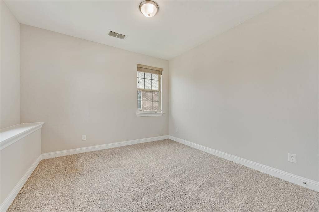 9829 Sharps Drive, Frisco, TX 75035 Neutral-toned interior space featuring wall-to-wall carpeting, a single-hung window, and a central ceiling-mounted light fixture