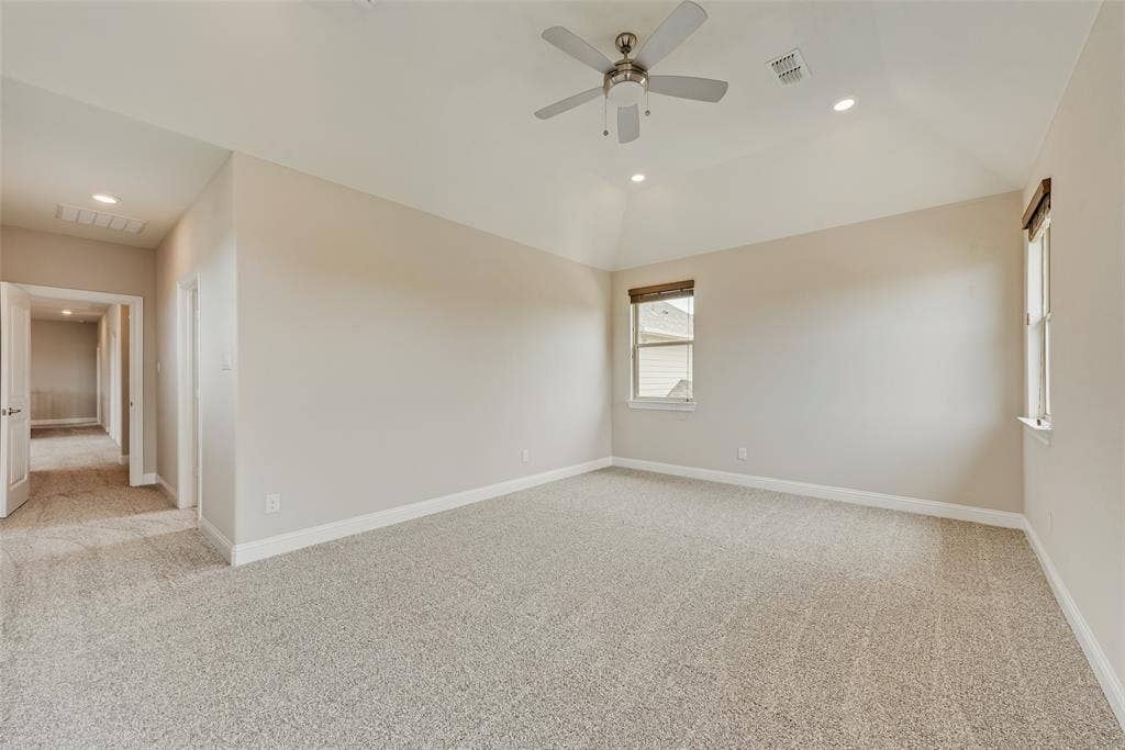 9829 Sharps Drive, Frisco, TX 75035 Vaulted ceiling with a central multi-blade ceiling fan, neutral wall tones, wall-to-wall carpeting, and recessed lighting
