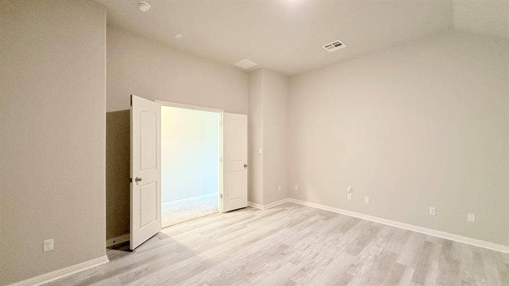 2937 Mossy Springs Drive, Leander, TX 78641 Vaulted ceilings, wood-finish flooring, and white double doors