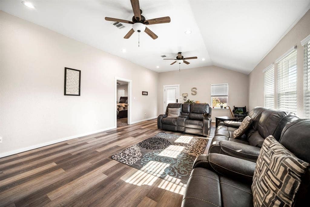 205 Newman Road, Ennis, TX 75119 Vaulted ceilings, wood-finish flooring, recessed lighting, and dual ceiling fans