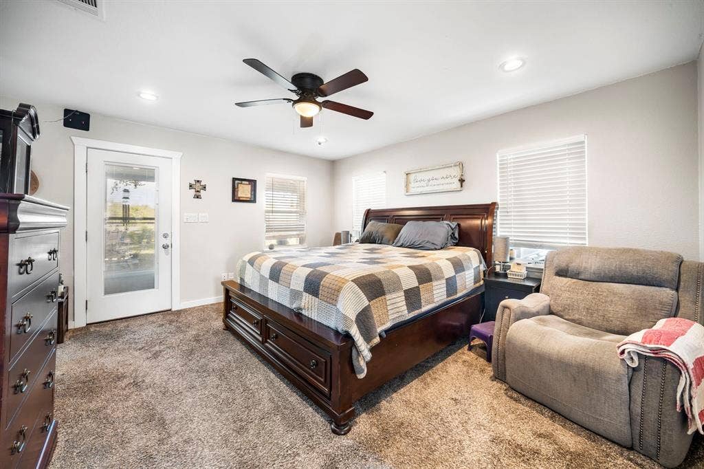 205 Newman Road, Ennis, TX 75119 Neutral-toned wall color, recessed lighting, ceiling fan, carpeting, and glass-panel door