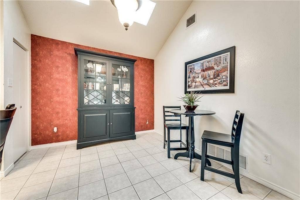 3702 Pulsar Drive, Garland, TX 75044 Vaulted ceiling with a recessed light fixture, built-in dark-toned hutch, and tile flooring