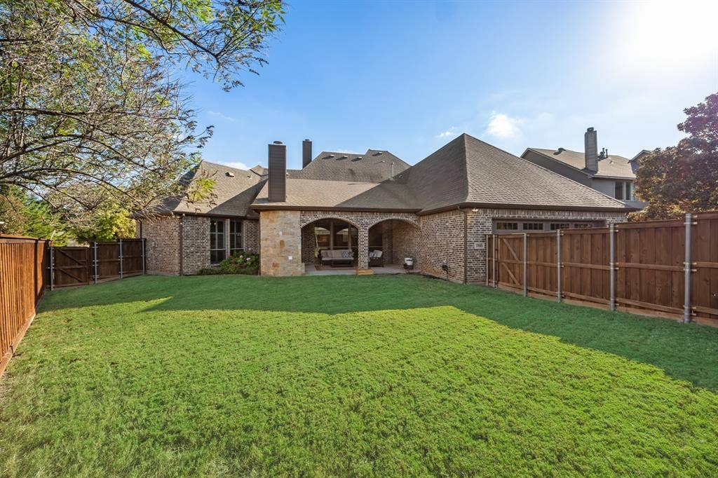 Spacious Backyard with Stained Board on Board Fence