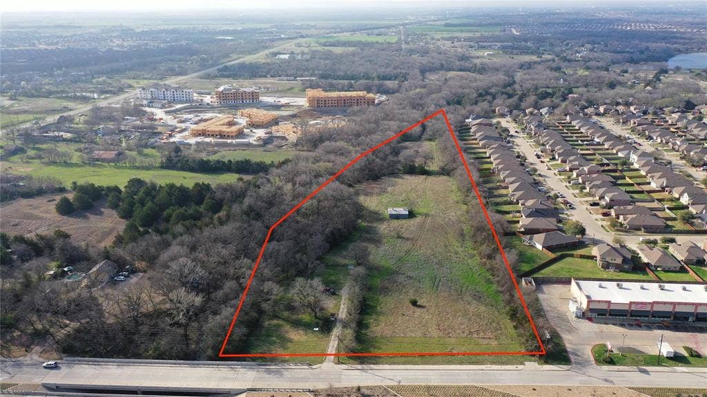 Expansive lot featuring a mix of cleared land and mature trees, offering a versatile canvas for development