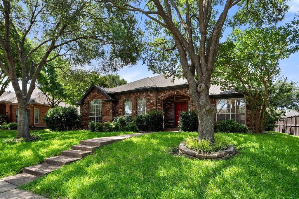 Single story home with brick siding and a shingled roof