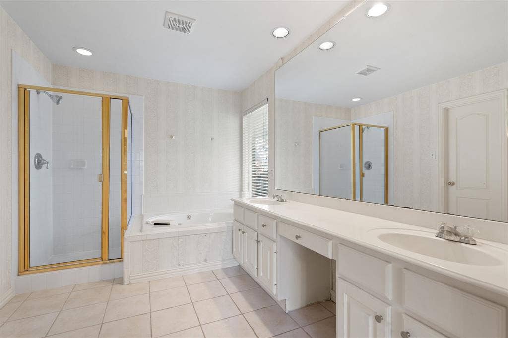 Full bathroom with a stall shower, a bath, double vanity, tile patterned floors, and recessed lighting