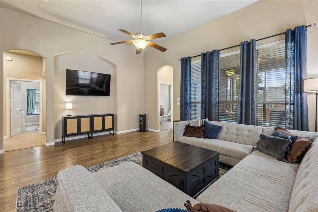 Another view of the living room showcases a spacious built-in TV niche and an open layout with easy access to both the primary and secondary bedrooms.