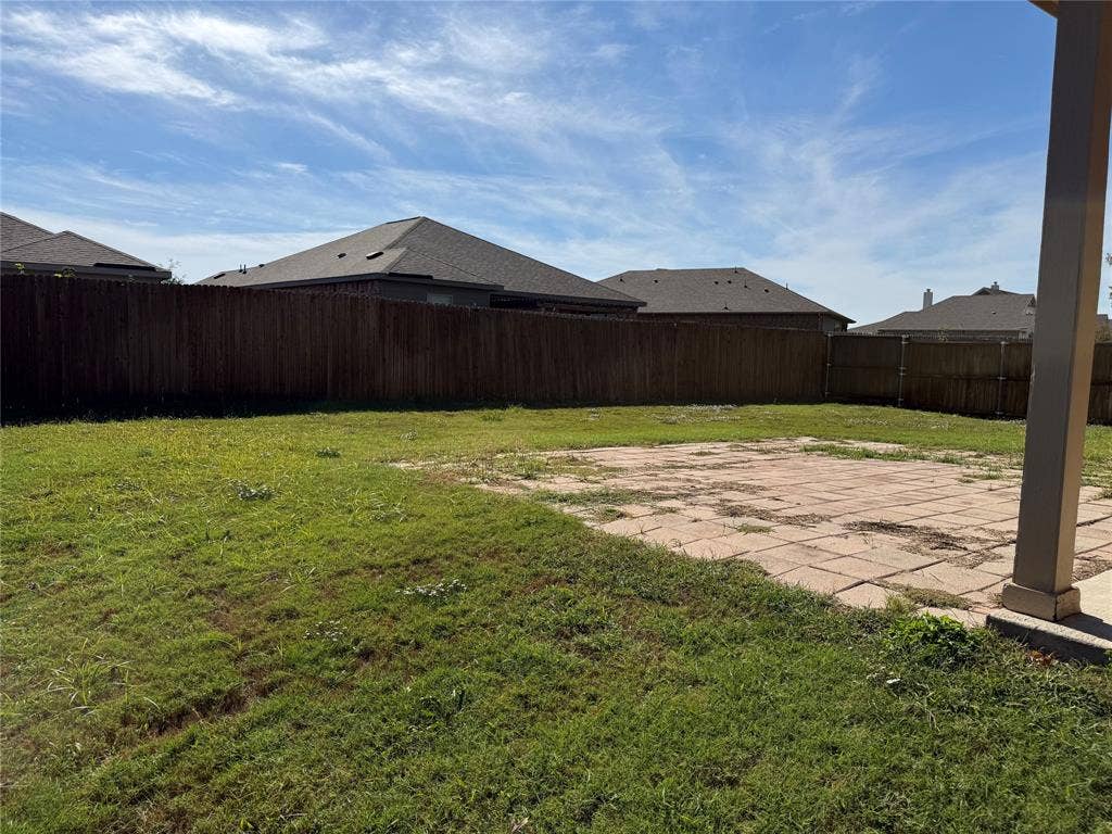 212 Belford Street S, Anna, TX 75409 Backyard featuring a paved stone patio, wood privacy fencing, and a grass lawn