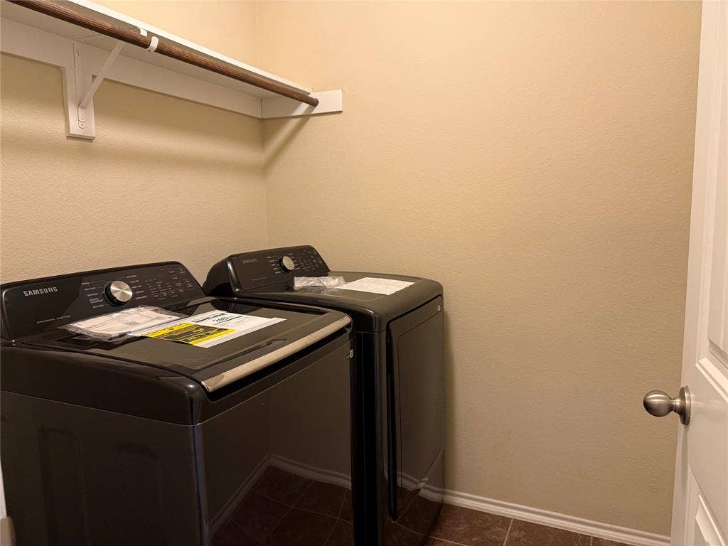 212 Belford Street S, Anna, TX 75409 Laundry room featuring a built-in hanging rod with an integrated upper storage shelf and tiled flooring