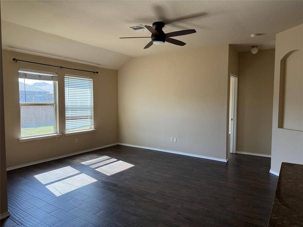 212 Belford Street S, Anna, TX 75409 Vaulted ceilings, wood-finish flooring, dual windows with blinds, a central ceiling fan, and a recessed wall niche