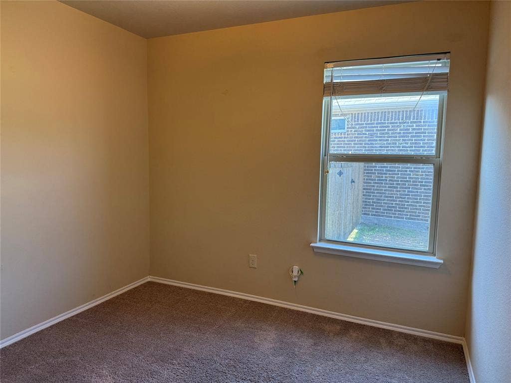 212 Belford Street S, Anna, TX 75409 Room featuring neutral wall tones, carpeted flooring, and a single-hung window with horizontal blinds