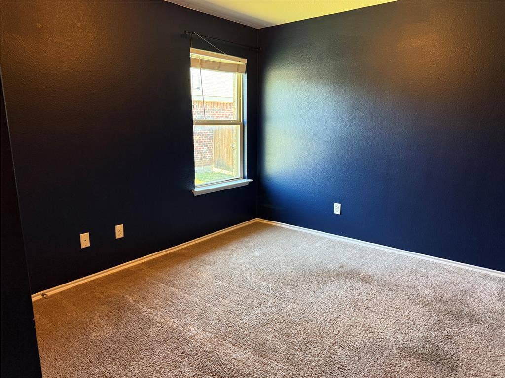 212 Belford Street S, Anna, TX 75409 Interior space featuring wall-to-wall carpeting and a single hung window with a white sill