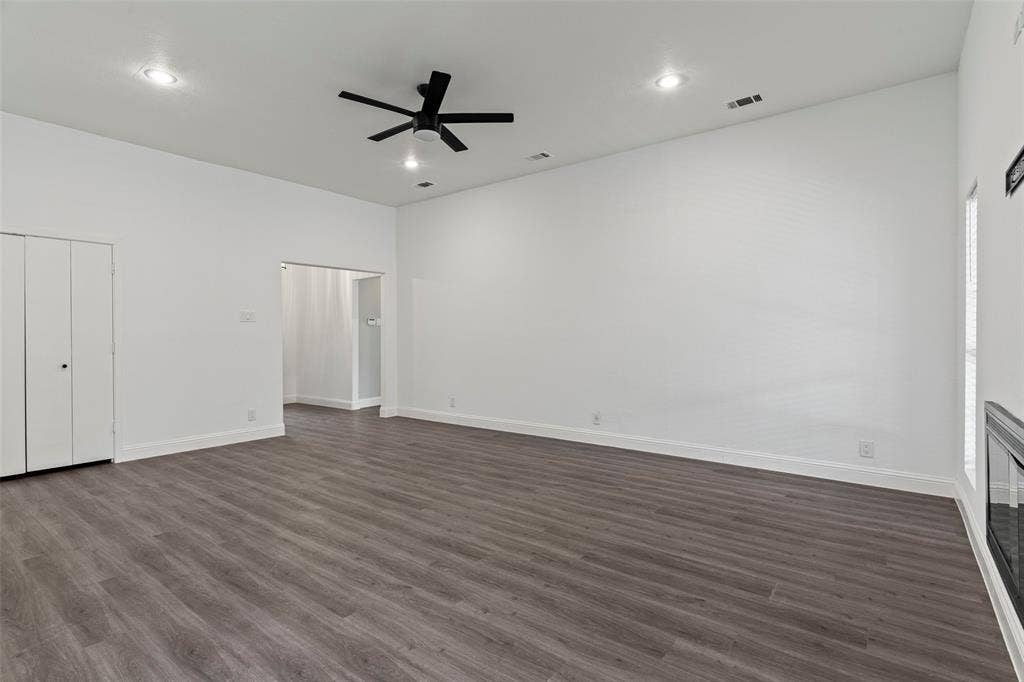 4128 Woodenrail Lane, Irving, TX 75061 Vaulted ceilings with recessed lighting, wood-finish flooring, built-in fireplace, and matte black ceiling fan