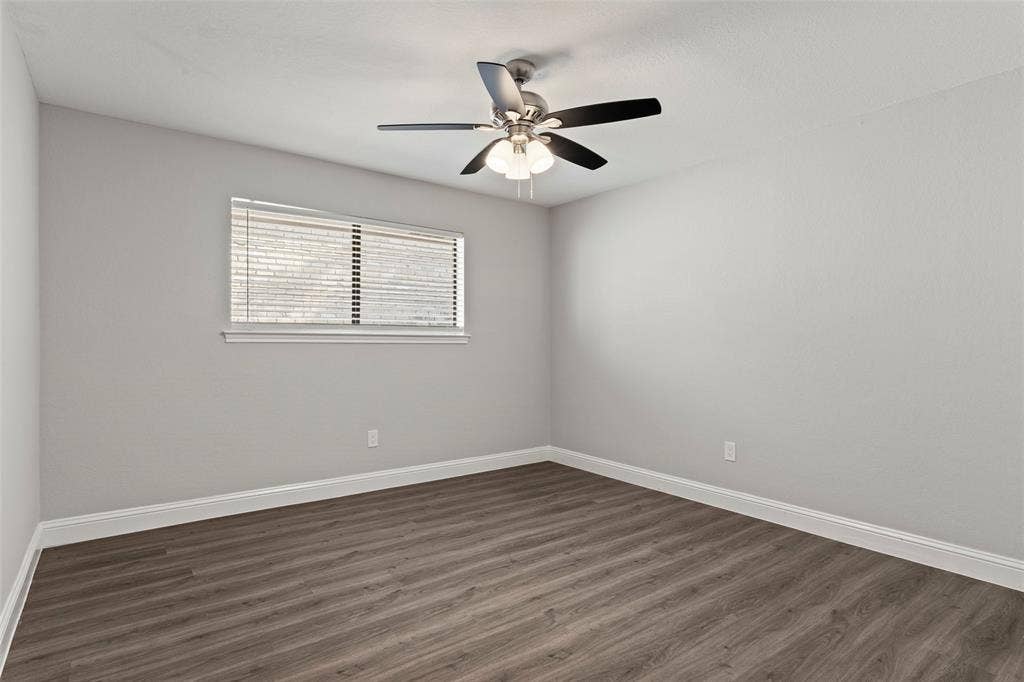 4128 Woodenrail Lane, Irving, TX 75061 Neutral interior featuring wood-finish flooring, a ceiling fan with integrated lighting, and a window with horizontal blinds