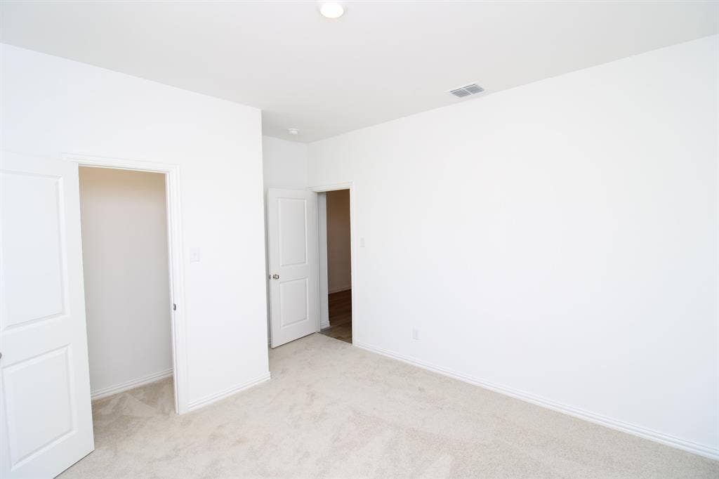 Neutral-toned carpet flooring, recessed lighting, and multi-panel interior doors