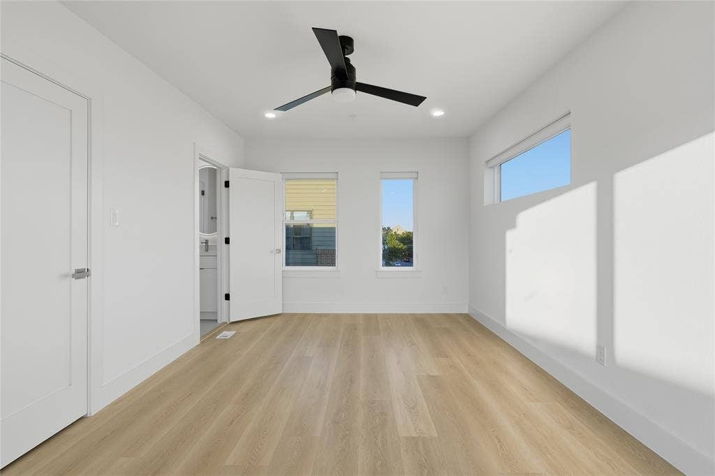 4319 San Jacinto Street, #101, Dallas, TX 75204 Room featuring wood-finish flooring, recessed lighting, a modern ceiling fan, multiple windows, and a horizontal clerestory window