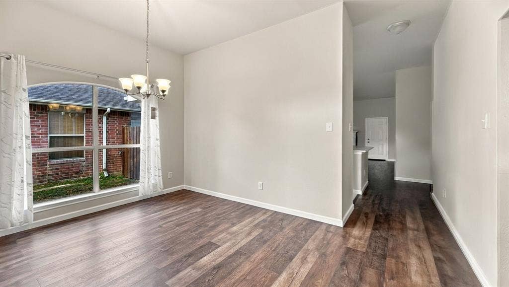 Vaulted ceilings, wood-finish flooring, stone-surround fireplace, tile flooring, and a kitchen island with stone-finish countertops