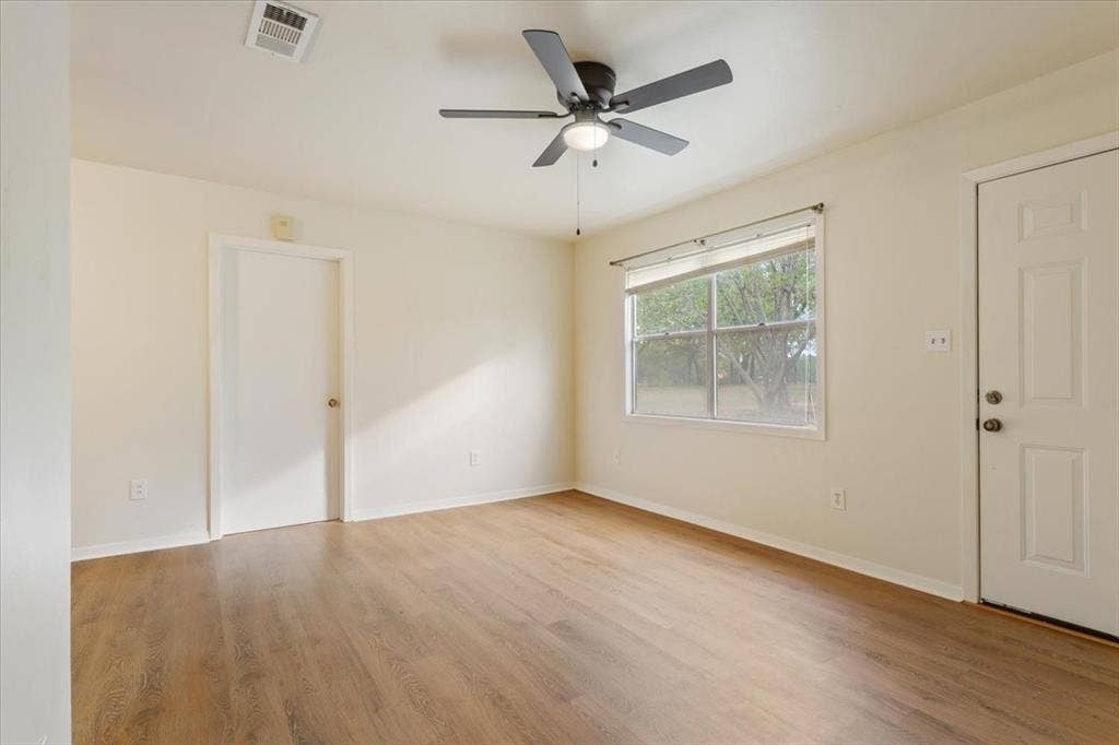 3907 Rogers Hill Road, Waco, TX 76705 Interior room featuring wood-finish flooring, neutral wall paint, and a central ceiling fan with integrated lighting