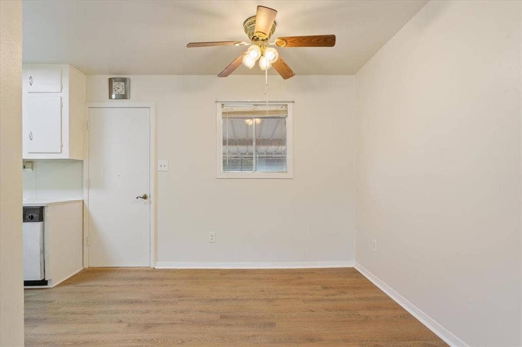 3907 Rogers Hill Road, Waco, TX 76705 Wood-finish flooring, white cabinetry, and a ceiling-mounted light fixture with a fan