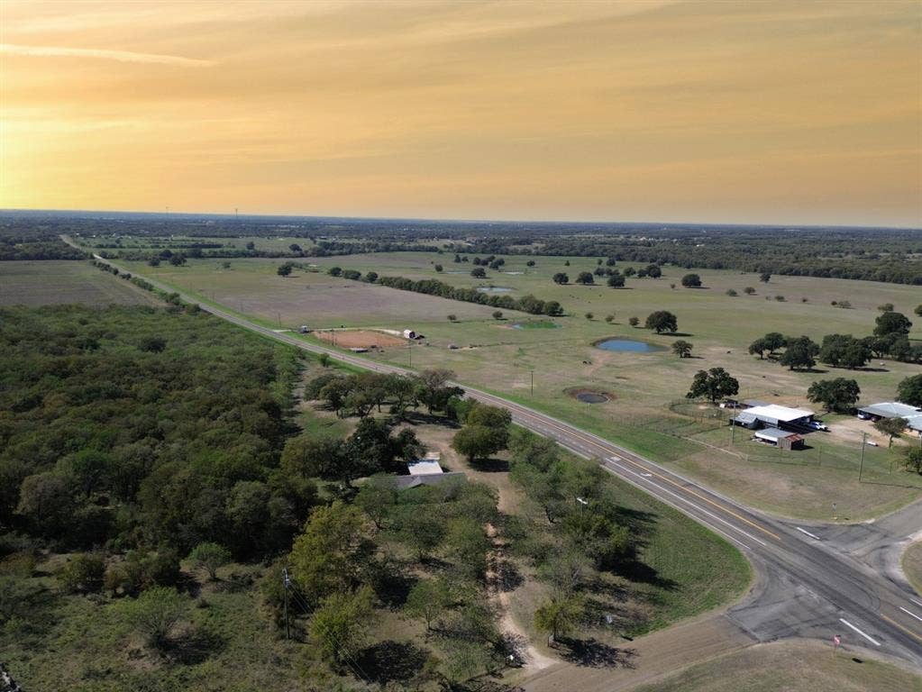 3907 Rogers Hill Road, Waco, TX 76705 Expansive acreage featuring mature tree clusters, open pasture land, and multiple natural ponds