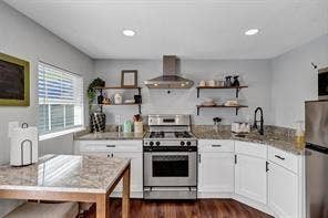 201 S Jones Street, Granbury, TX 76048 Kitchen featuring white shaker-style cabinetry, stone-surface countertops, stainless steel range with a professional-style vent hood, open shelving, and wood-finish flooring